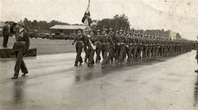 Personnel from 300 (Polish) Sqn photographed at a parade and hangar service at RAF Faldingworth on 1 Jul 1945.